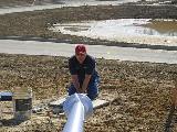 Holding the base of the flagpole
